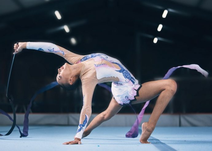 Groß (ribbon-gymnastics-and-flexible-woman-stretching-i-2025-04-06-09-03-19-utc)